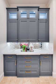 gray cabinetry with gold hardware