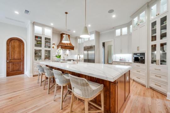 kitchen island with marble countertop and wooden cabinetry