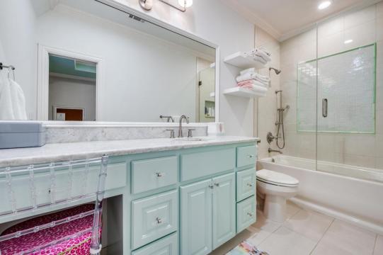bathroom remodel with light blue cabinetry