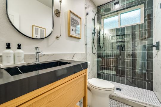 green tile backsplash with glass shower door