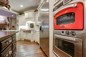 Home Remodeling - Updated kitchen with red microwave and red accents