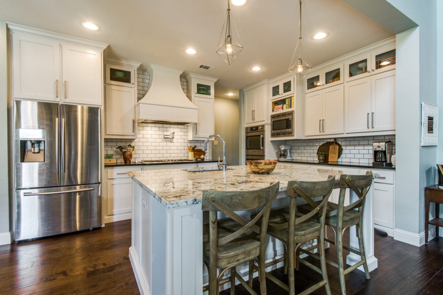 kitchen design trends - remodeled kitchen with white cabinets and subway tile backsplash