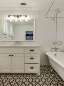 Home Remodeling - White bathroom with white and black statement tile flooring