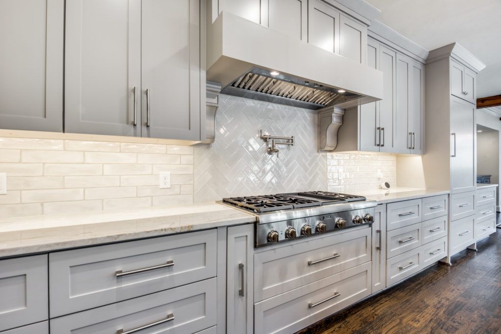 kitchen backsplash with white subway tile in a herringbone pattern