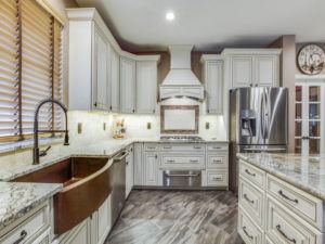 kitchen design trends - remodeled kitchen with light cabinets and decorative sink