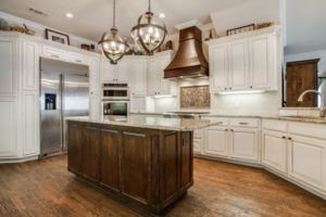 kitchen design trends - kitchen with wood centerpiece range hood over stove