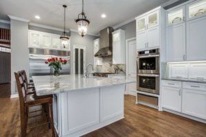 kitchen design trends - remodeled kitchen with white cabinets and stainless steel appliances