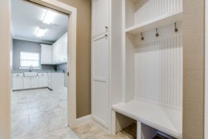 back to school organization tips - mudroom with hooks and bench outside of laundry room 