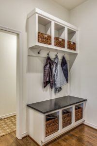 back to school organization tips - hooks and seating bench in entryway of home