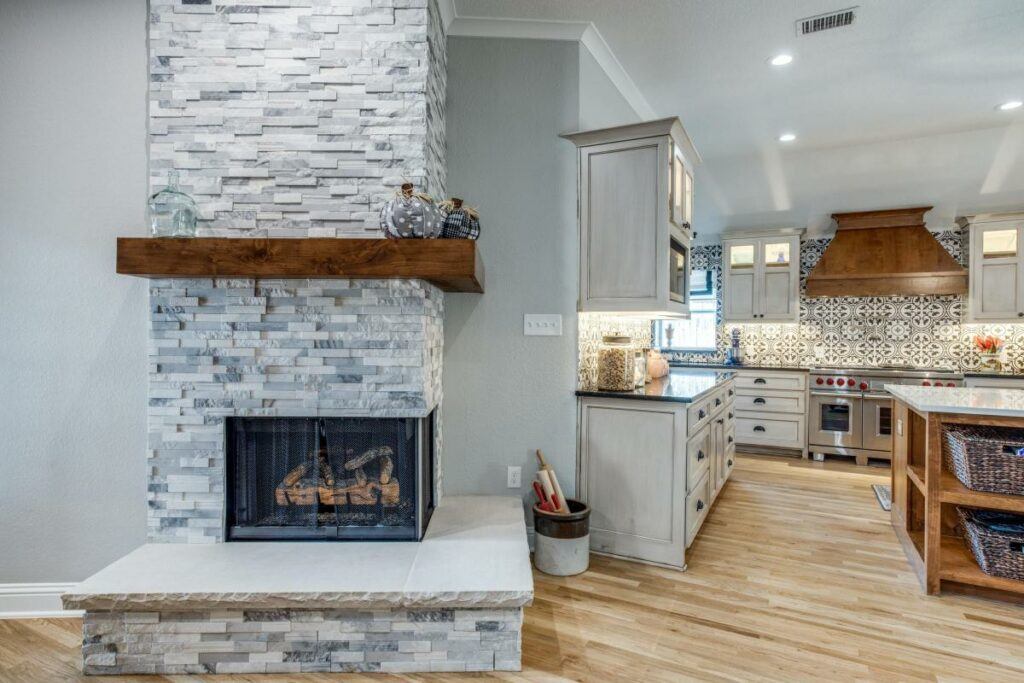 brick fireplace leading into kitchen.
