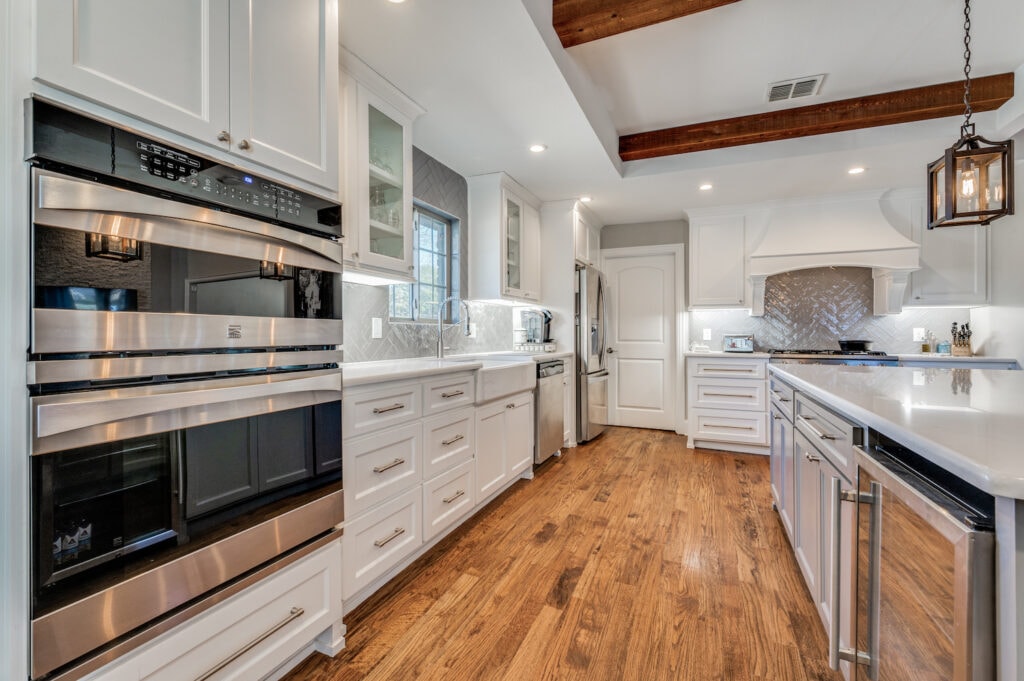 kitchen remodel in Plano with white cabinets and gray backsplash - The Hidden Costs of Kitchen Remodeling and How to Avoid Them