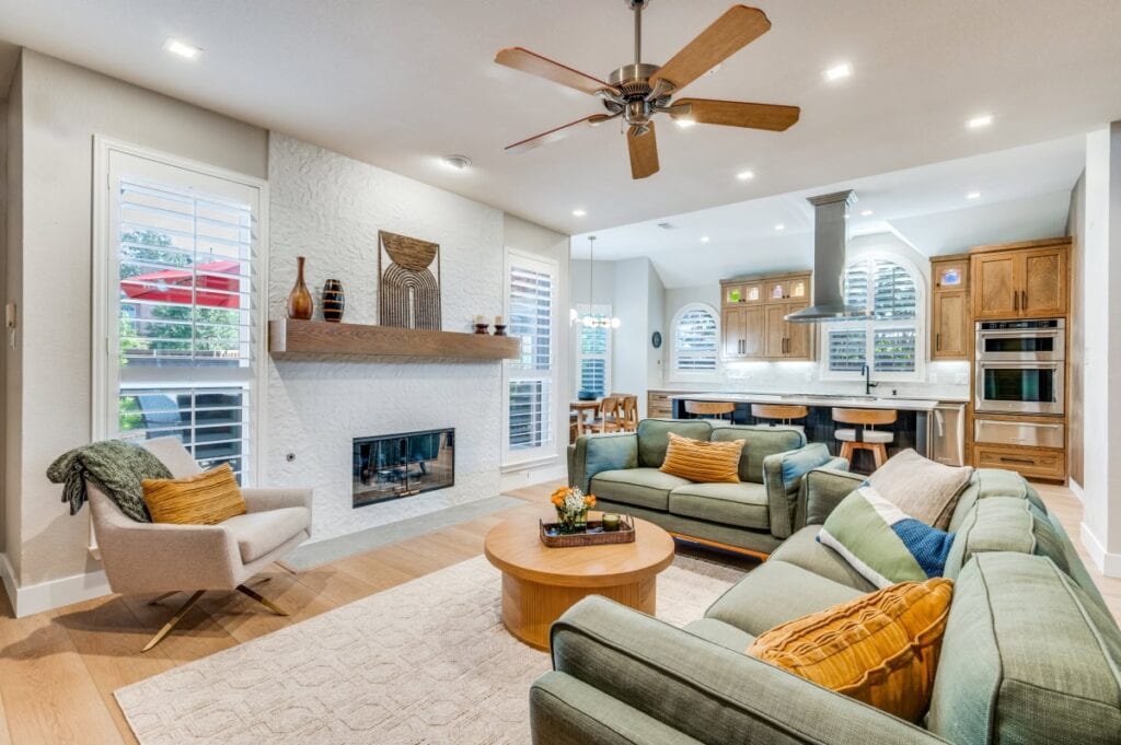 Remodeled open-concept kitchen with adjoining stone fireplace in a Plano, TX home