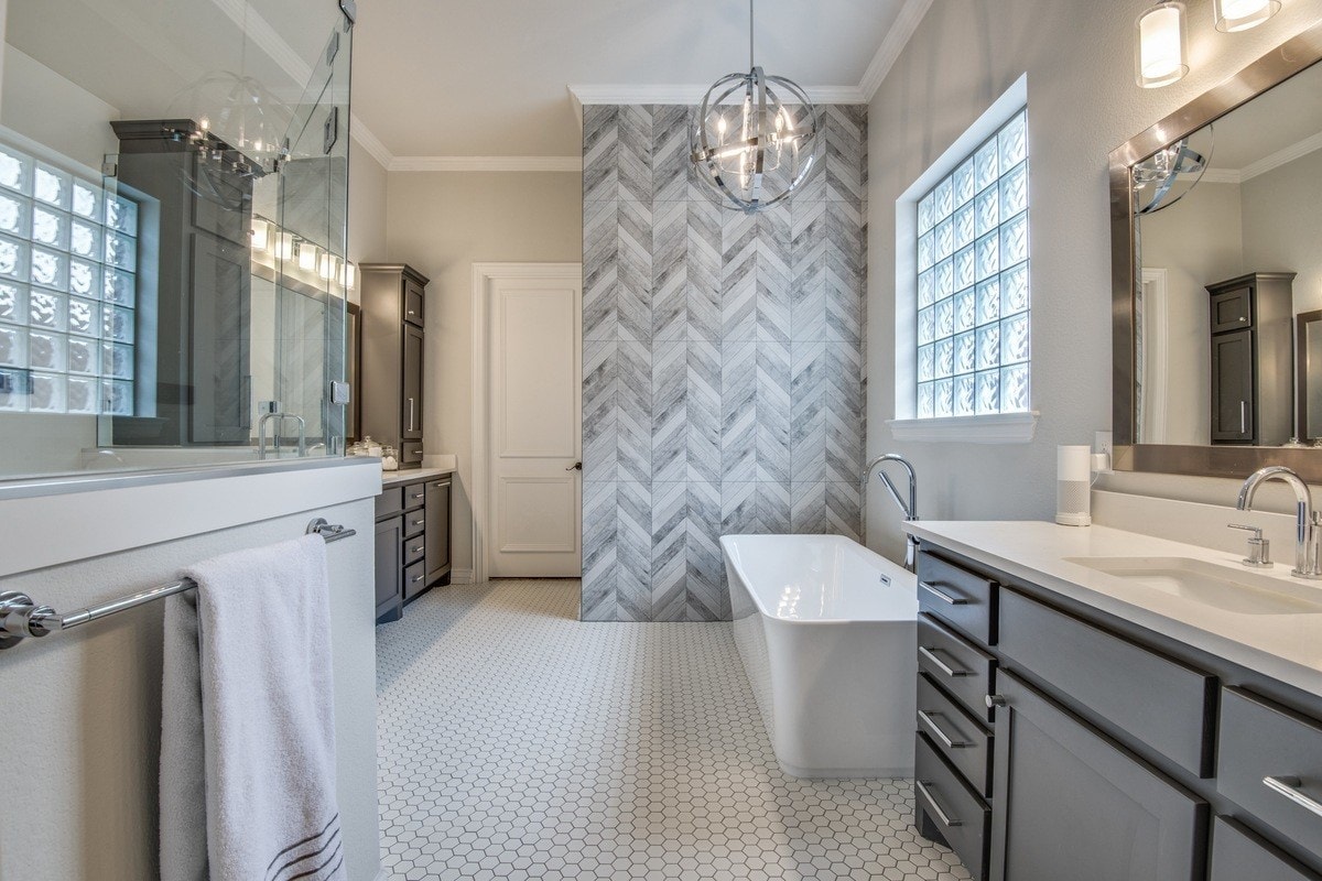 bathroom remodel - updated grey and white bathroom with accent wall and white bathtub